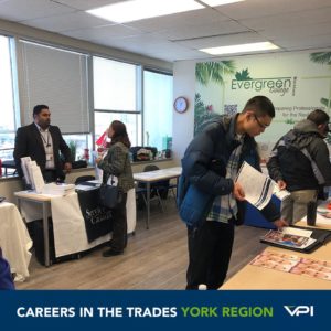 Job Seekers speak to exhibitors from Service Canada and Bliss Aesthetics about opportunities in the trades at Evergreen College in York Region.