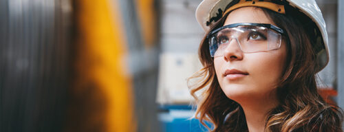 A close-up of a woman wearing workplace protective gear