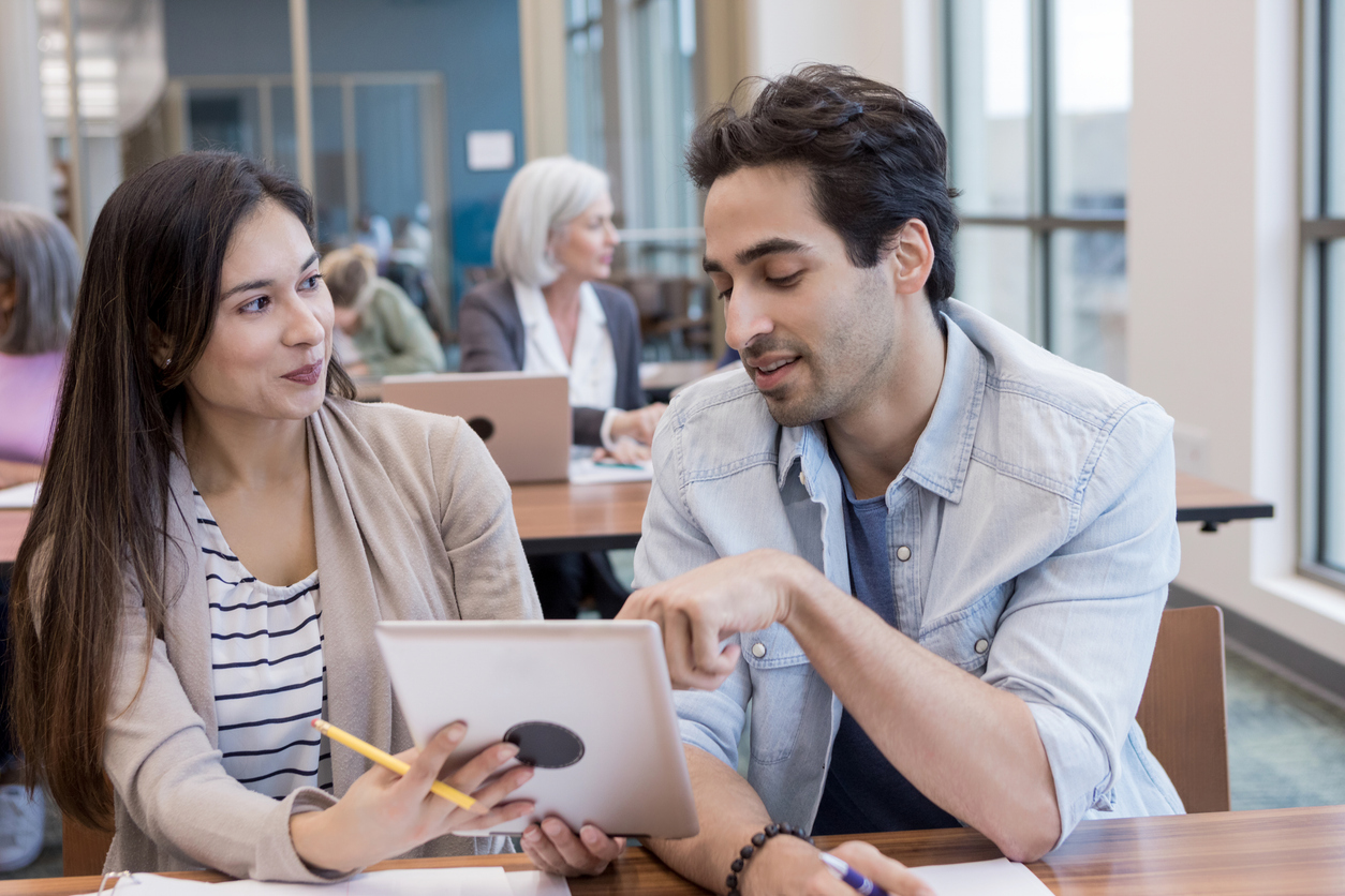Girlfriend listens as boyfriend explains website